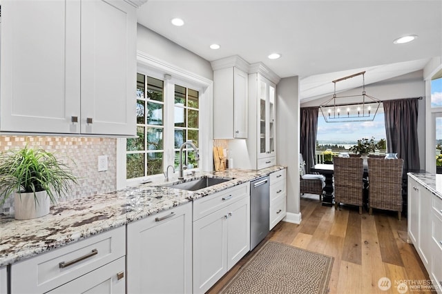 kitchen featuring a sink, stainless steel dishwasher, decorative backsplash, white cabinets, and recessed lighting