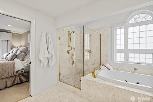 ensuite bathroom with healthy amount of natural light, a whirlpool tub, a shower stall, and baseboards