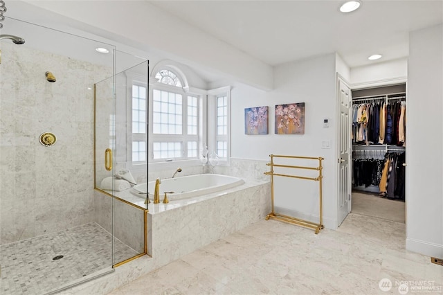 full bathroom with a shower stall, a garden tub, recessed lighting, and a spacious closet