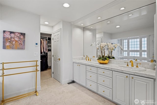 full bath featuring recessed lighting, double vanity, and a walk in closet