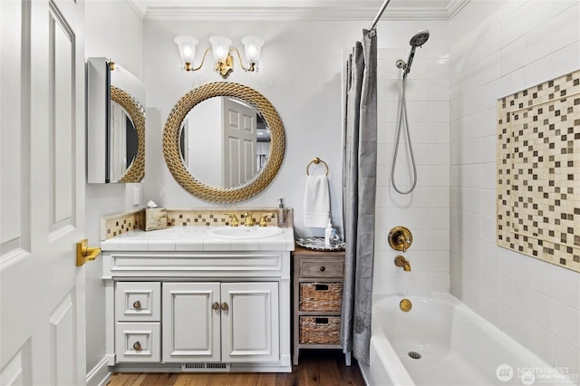 bathroom featuring crown molding, shower / bath combination with curtain, vanity, and wood finished floors