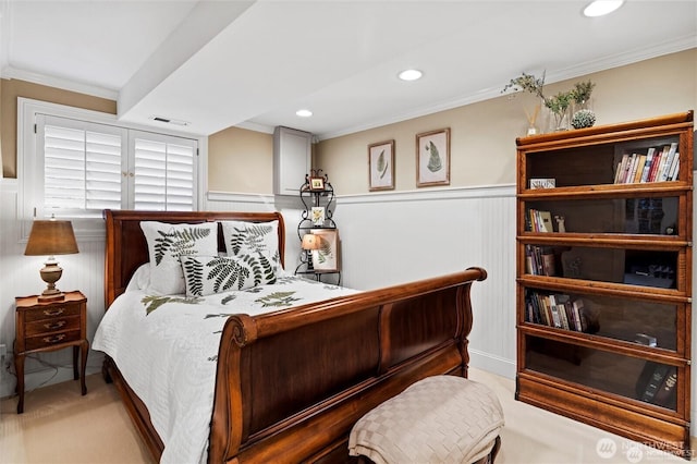bedroom with carpet flooring, crown molding, wainscoting, recessed lighting, and a decorative wall