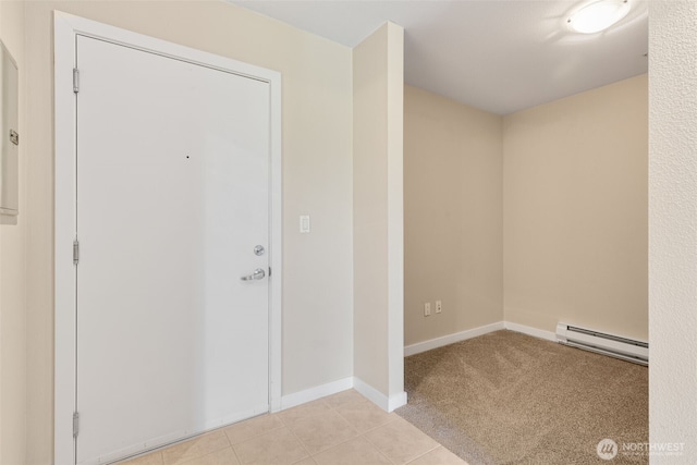 303 23rd Ave S Unit 308, Seattle, WA 98144 - entrance foyer with a baseboard radiator, baseboards, light tile patterned floors, and light colored carpet