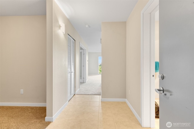 303 23rd Ave S Unit 308, Seattle, WA 98144 - hallway with light carpet, baseboards, and light tile patterned flooring