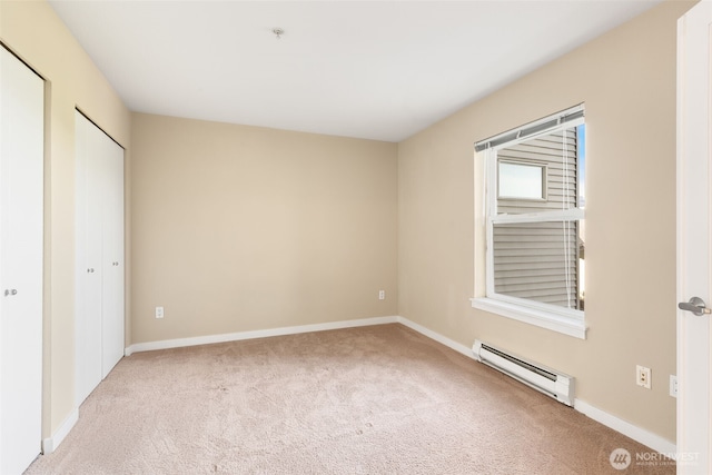 303 23rd Ave S Unit 308, Seattle, WA 98144 - unfurnished bedroom featuring a baseboard radiator, carpet flooring, and baseboards