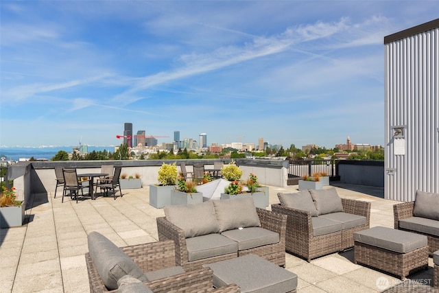 303 23rd Ave S Unit 308, Seattle, WA 98144 - view of patio featuring an outdoor living space, a skyline view, and outdoor dining area