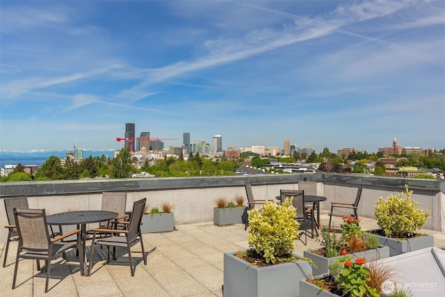 303 23rd Ave S Unit 308, Seattle, WA 98144 - view of patio with a view of skyline and outdoor dining area