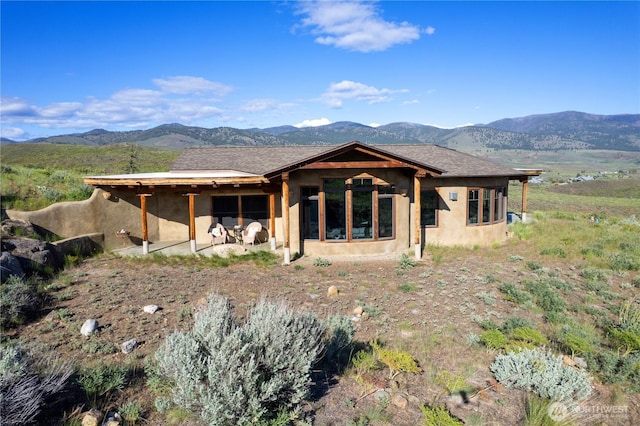 3B Johnny Haase Ln, Winthrop, WA 98862 - back of property featuring a mountain view, stucco siding, and a patio area