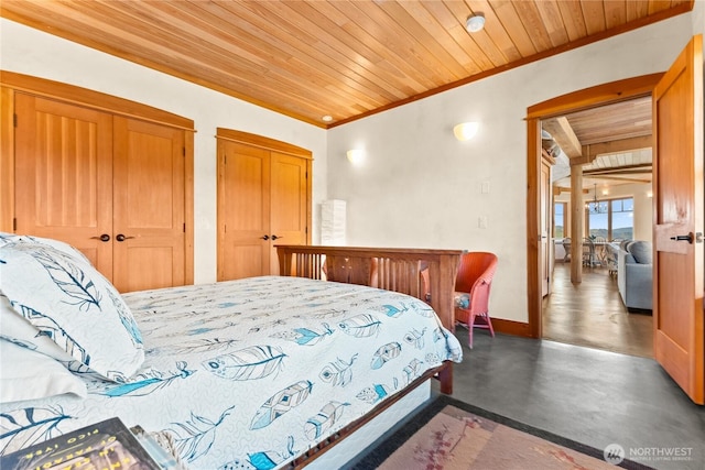 3B Johnny Haase Ln, Winthrop, WA 98862 - bedroom featuring ornamental molding, two closets, wooden ceiling, baseboards, and finished concrete flooring