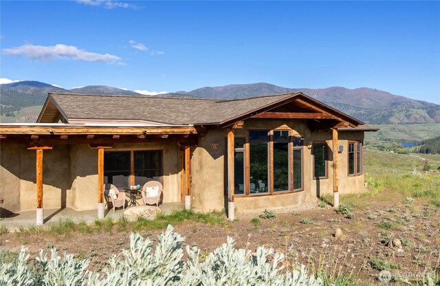 3B Johnny Haase Ln, Winthrop, WA 98862 - back of property featuring a mountain view, a patio, and stucco siding