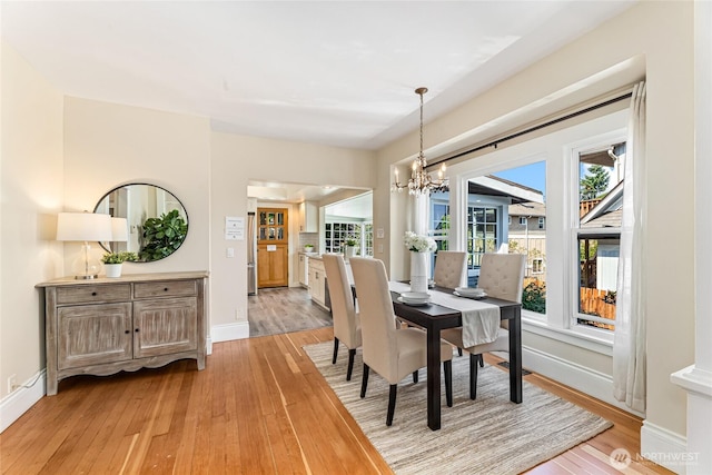 746 N 89th St, Seattle, WA 98103 - dining space featuring light wood finished floors, a chandelier, and baseboards