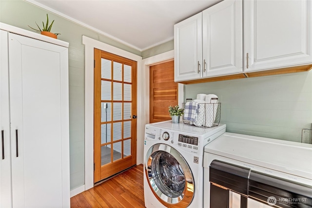 746 N 89th St, Seattle, WA 98103 - washroom featuring washer and clothes dryer, light wood-type flooring, crown molding, and cabinet space