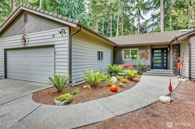 30 Hemlock Ct, Port Townsend, WA 98368 - view of front of house featuring a garage, concrete driveway, and board and batten siding