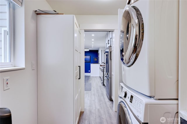 30 Hemlock Ct, Port Townsend, WA 98368 - laundry room featuring stacked washing machine and dryer and light wood-style flooring