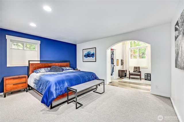 30 Hemlock Ct, Port Townsend, WA 98368 - bedroom featuring arched walkways, carpet flooring, recessed lighting, and a walk in closet