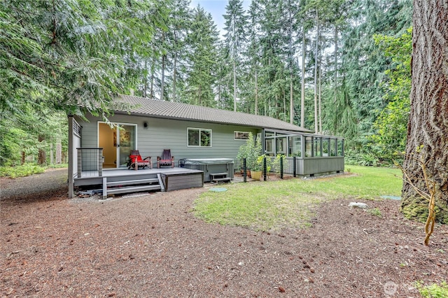 30 Hemlock Ct, Port Townsend, WA 98368 - rear view of house featuring a hot tub, a wooden deck, a sunroom, and a lawn