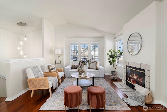 12408 1st Ave SW, Seattle, WA 98146 - living area featuring a tiled fireplace, wood finished floors, lofted ceiling, and baseboards