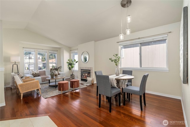 12408 1st Ave SW, Seattle, WA 98146 - dining room with a fireplace, wood-type flooring, vaulted ceiling, and baseboards