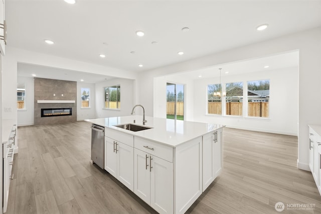 20263 145th St E Unit 857, Bonney Lake, WA 98391 - kitchen featuring a sink, open floor plan, dishwasher, light wood-type flooring, and an island with sink