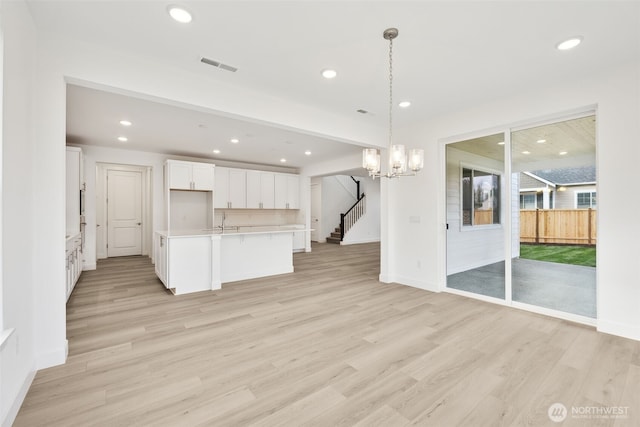20263 145th St E Unit 857, Bonney Lake, WA 98391 - kitchen featuring light countertops, light wood-style floors, recessed lighting, and white cabinets