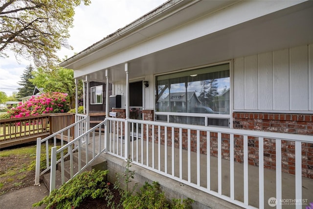 1122 G St, Centralia, WA 98531 - view of exterior entry featuring a porch and brick siding