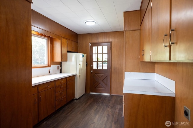 1122 G St, Centralia, WA 98531 - kitchen with freestanding refrigerator, light countertops, brown cabinets, healthy amount of natural light, and wood walls