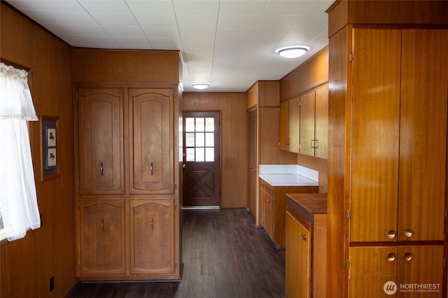 1122 G St, Centralia, WA 98531 - kitchen with brown cabinetry, dark wood-style flooring, and wooden walls