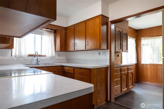 1122 G St, Centralia, WA 98531 - kitchen featuring a sink, brown cabinetry, healthy amount of natural light, light countertops, and wood walls