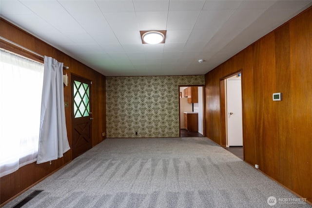 1122 G St, Centralia, WA 98531 - empty room with carpet floors, wood walls, and wallpapered walls