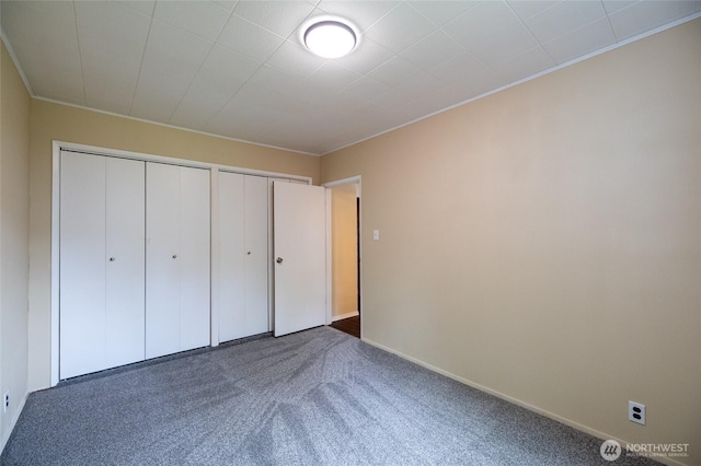 1122 G St, Centralia, WA 98531 - unfurnished bedroom with two closets, carpet, ornamental molding, and baseboards