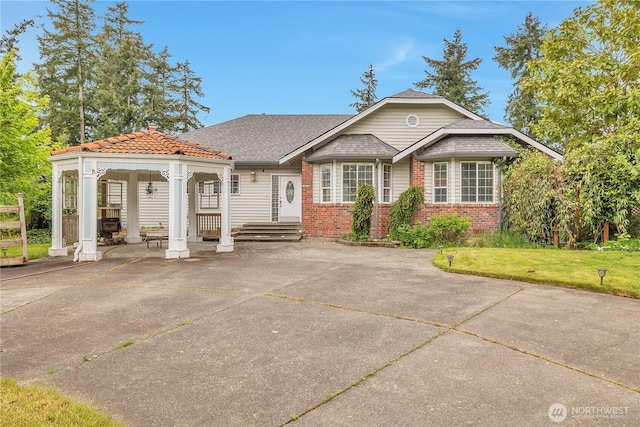 31637 107th Ave SE, Auburn, WA 98092 - view of front of house with brick siding, a front lawn, and a gazebo