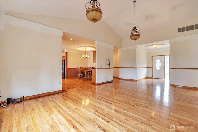 31637 107th Ave SE, Auburn, WA 98092 - unfurnished living room with wood finished floors, a chandelier, baseboards, and lofted ceiling