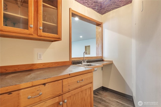 31637 107th Ave SE, Auburn, WA 98092 - kitchen with a sink, dark wood-style floors, glass insert cabinets, and baseboards