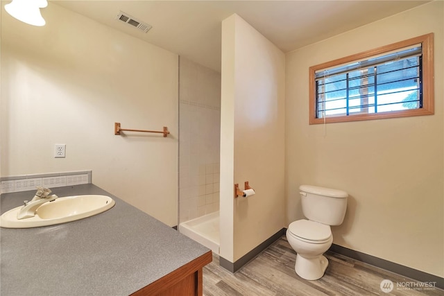 31637 107th Ave SE, Auburn, WA 98092 - full bath featuring toilet, wood finished floors, a tile shower, and vanity
