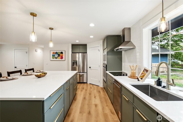 3598 Breeze Way NW, Bremerton, WA 98312 - kitchen with stainless steel appliances, a sink, wall chimney range hood, light countertops, and light wood-style floors