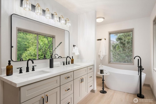4102 205th Ave SE, Sammamish, WA 98075 - full bathroom with a freestanding tub, double vanity, and wood finished floors