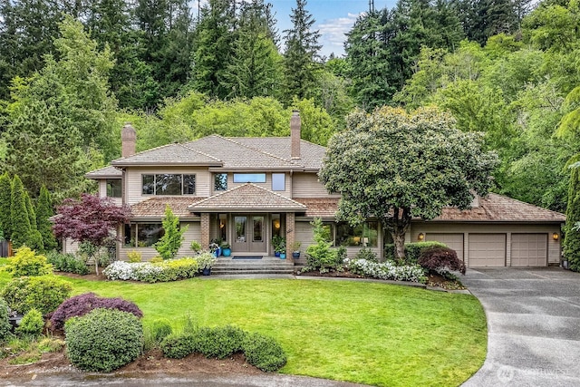 4102 205th Ave SE, Sammamish, WA 98075 - view of front of property featuring a chimney, driveway, a front yard, and an attached garage
