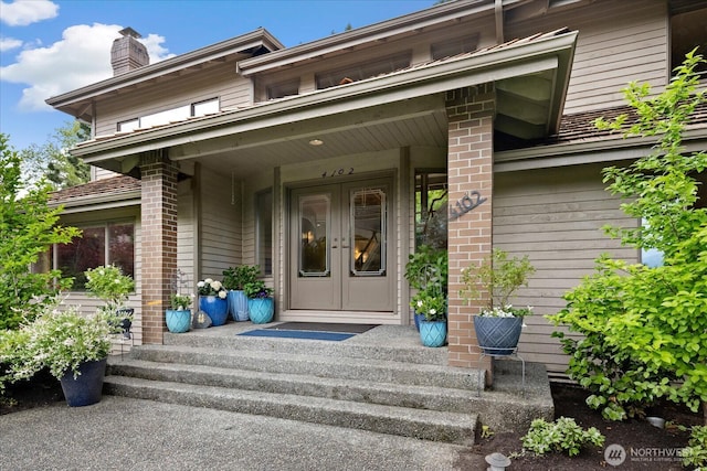 4102 205th Ave SE, Sammamish, WA 98075 - property entrance with french doors, a chimney, and brick siding