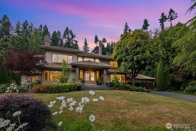 4102 205th Ave SE, Sammamish, WA 98075 - prairie-style house featuring a chimney, a front lawn, and french doors