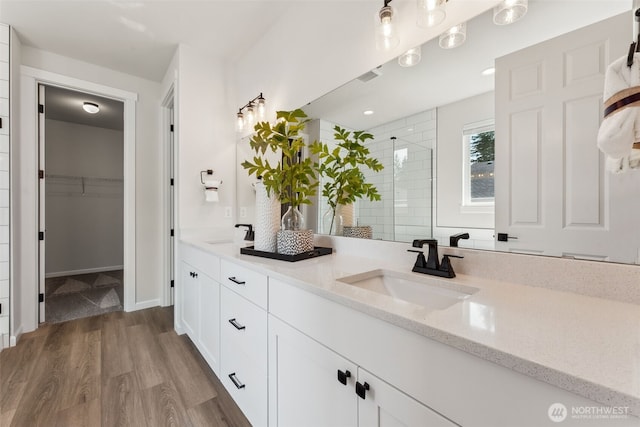 20307 145th St E Unit 860, Bonney Lake, WA 98391 - full bath with wood finished floors, tiled shower, double vanity, and a walk in closet