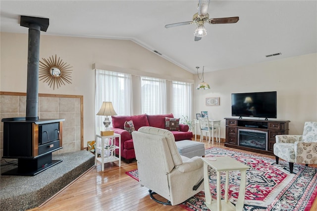 2412 Mulberry St, Longview, WA 98632 - living room with a wood stove, wood finished floors, a ceiling fan, and vaulted ceiling
