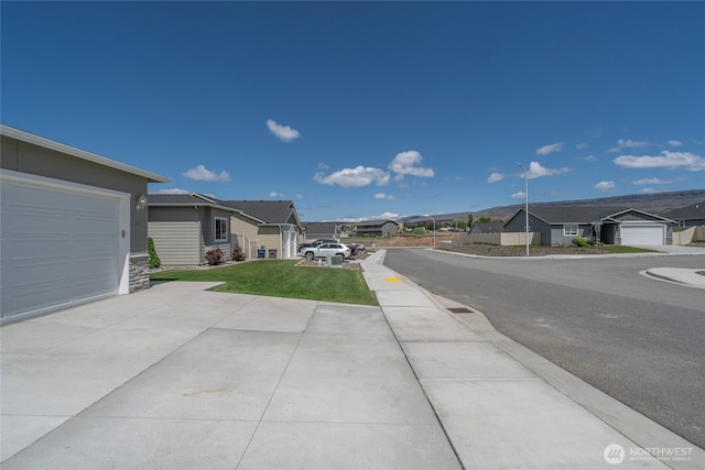 28 S Millbrook, East Wenatchee, WA 98802 - view of asphalt road with a residential view, street lighting, and sidewalks
