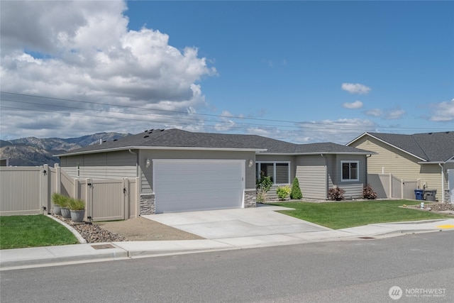 28 S Millbrook, East Wenatchee, WA 98802 - ranch-style house with a gate, a garage, concrete driveway, stone siding, and a mountain view