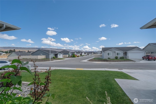 28 S Millbrook, East Wenatchee, WA 98802 - view of green lawn with a residential view and concrete driveway