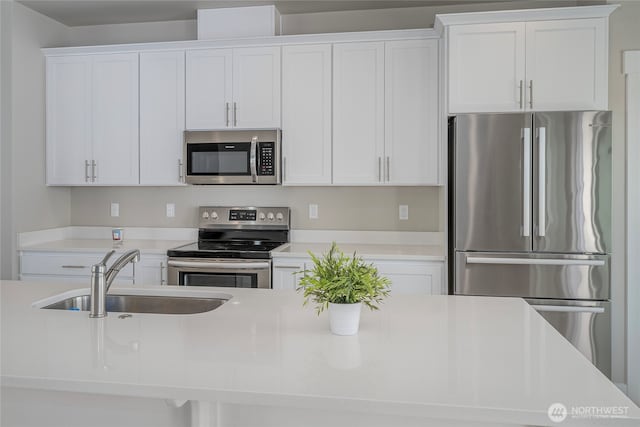 28 S Millbrook, East Wenatchee, WA 98802 - kitchen with appliances with stainless steel finishes, a sink, white cabinetry, and light countertops