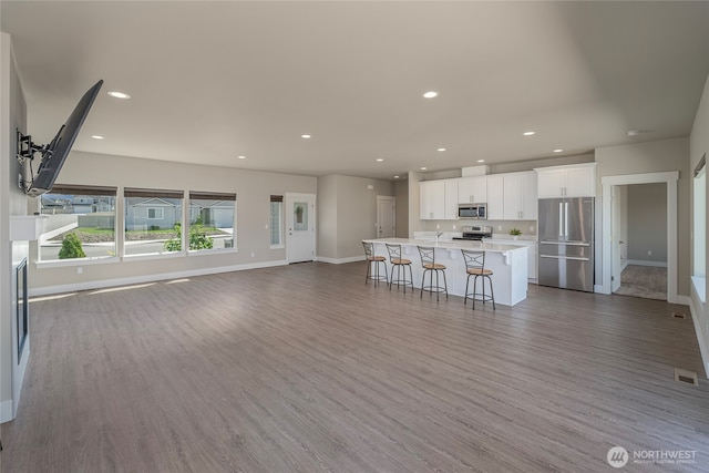 28 S Millbrook, East Wenatchee, WA 98802 - unfurnished living room featuring baseboards, wood finished floors, and recessed lighting
