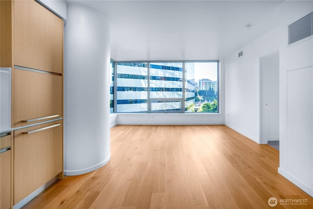 1808 Minor Ave Unit 912, Seattle, WA 98101 - unfurnished living room featuring light wood finished floors and baseboards