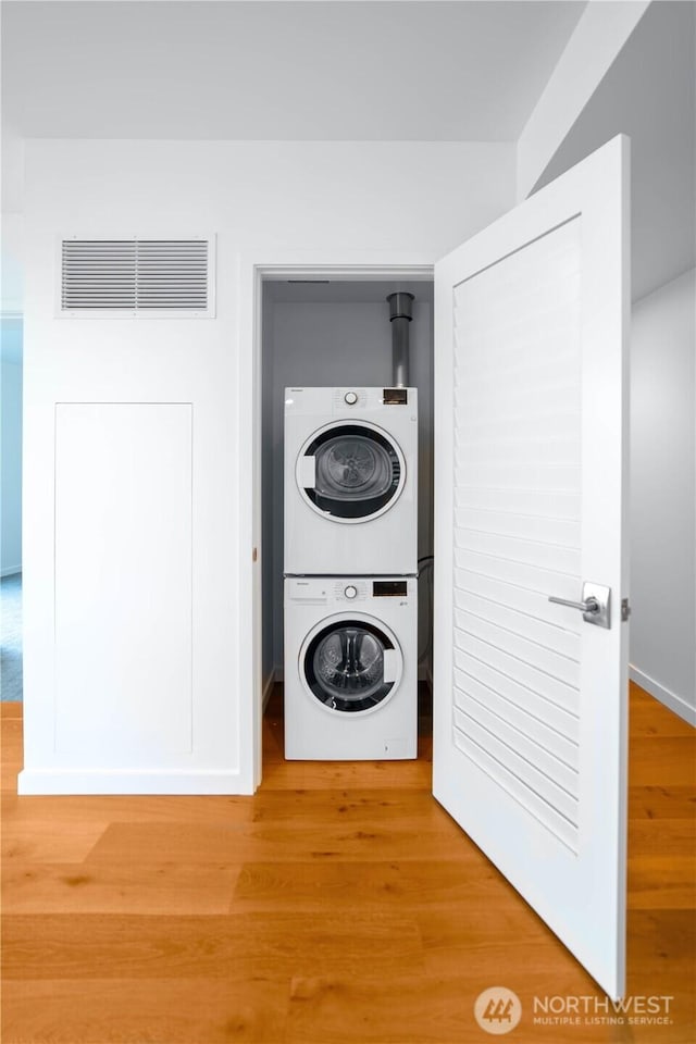 1808 Minor Ave Unit 912, Seattle, WA 98101 - laundry area featuring estacked washer and dryer and wood finished floors
