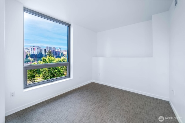 1808 Minor Ave Unit 912, Seattle, WA 98101 - carpeted empty room featuring a view of city and baseboards