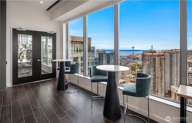 1808 Minor Ave Unit 912, Seattle, WA 98101 - sunroom / solarium featuring healthy amount of natural light, a city view, french doors, and a water view